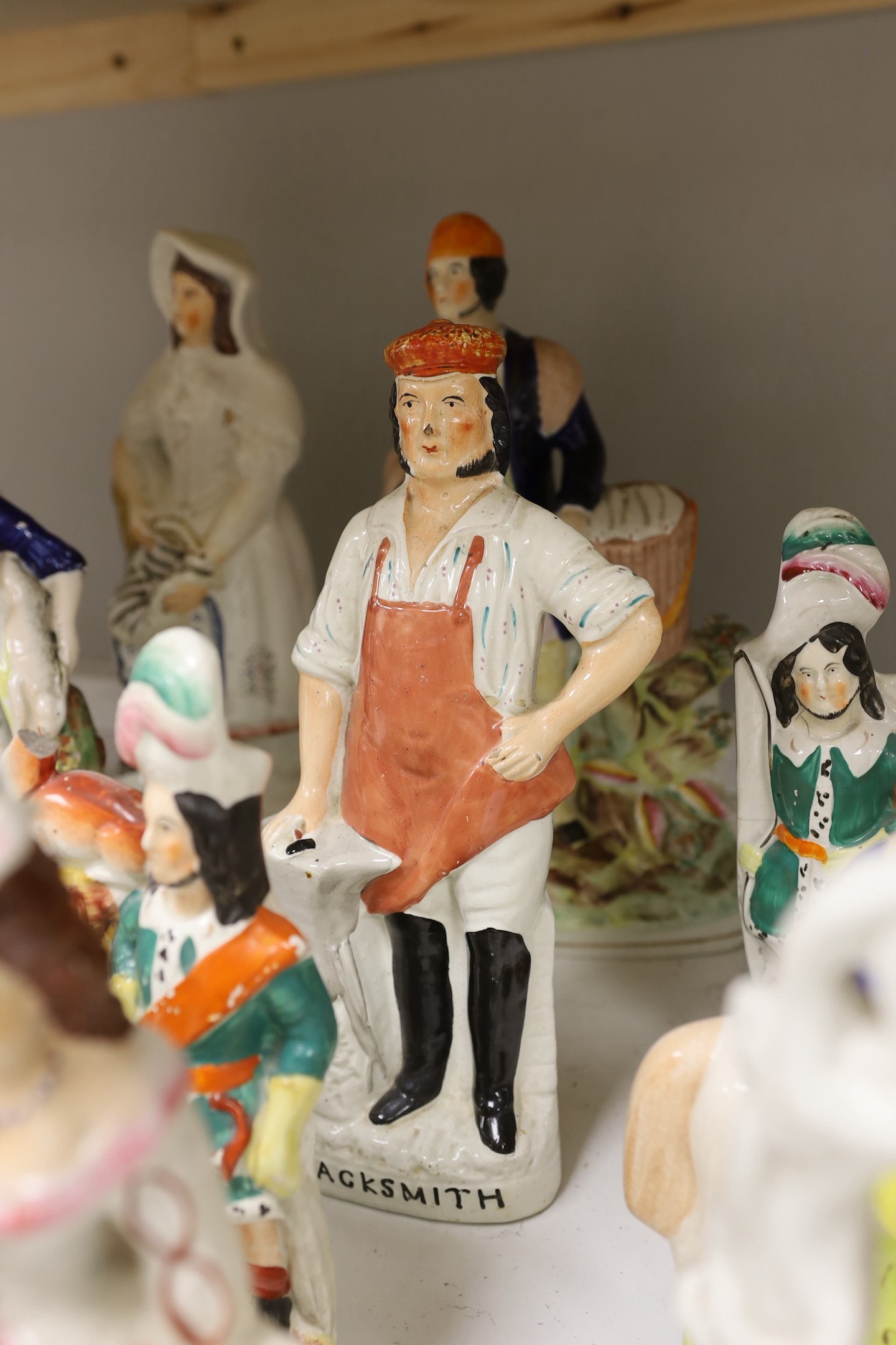 A group of Staffordshire pottery and porcellaneous figures and groups, The tallest 42 cm